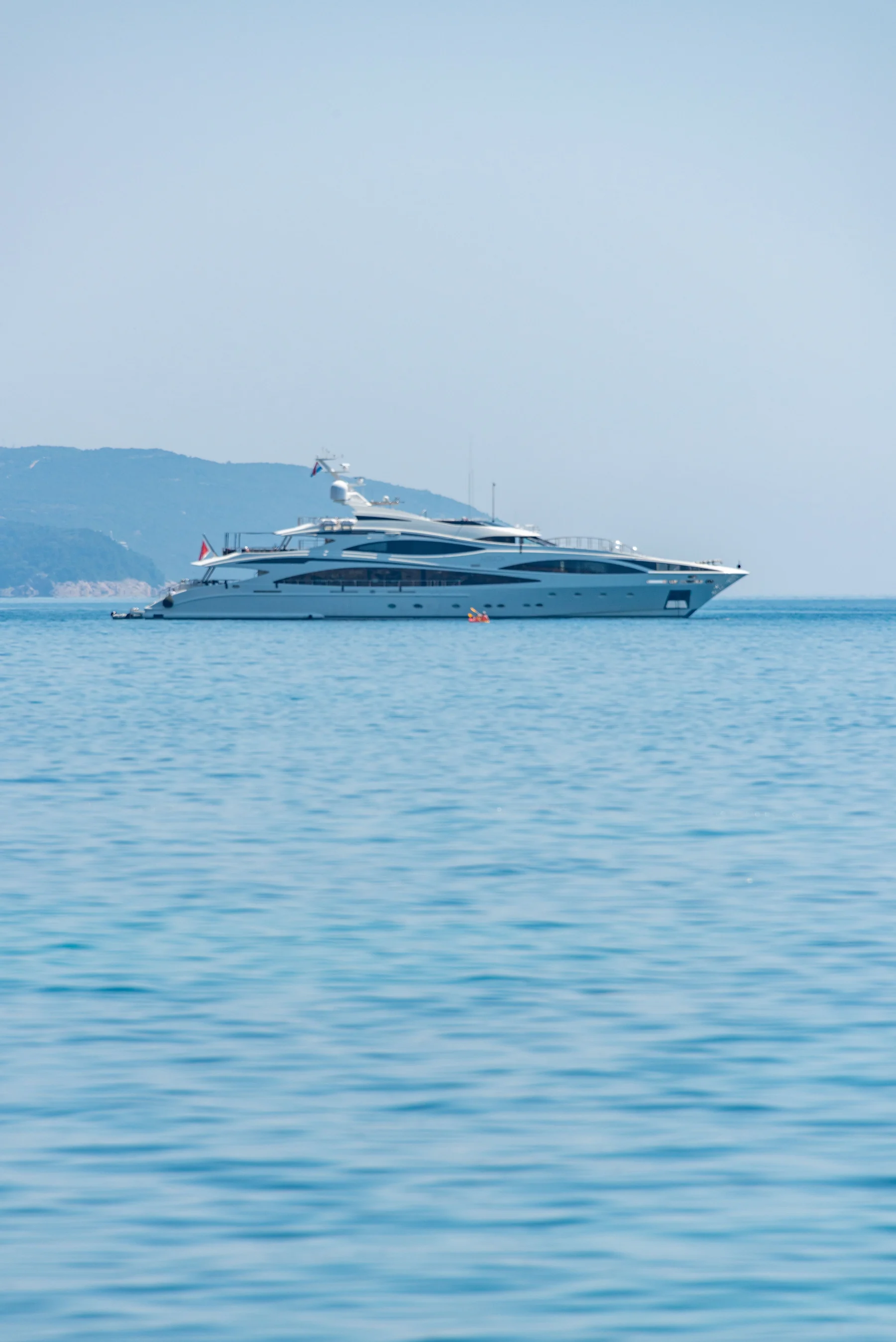 Real photograph of a large private megayacht at sea.