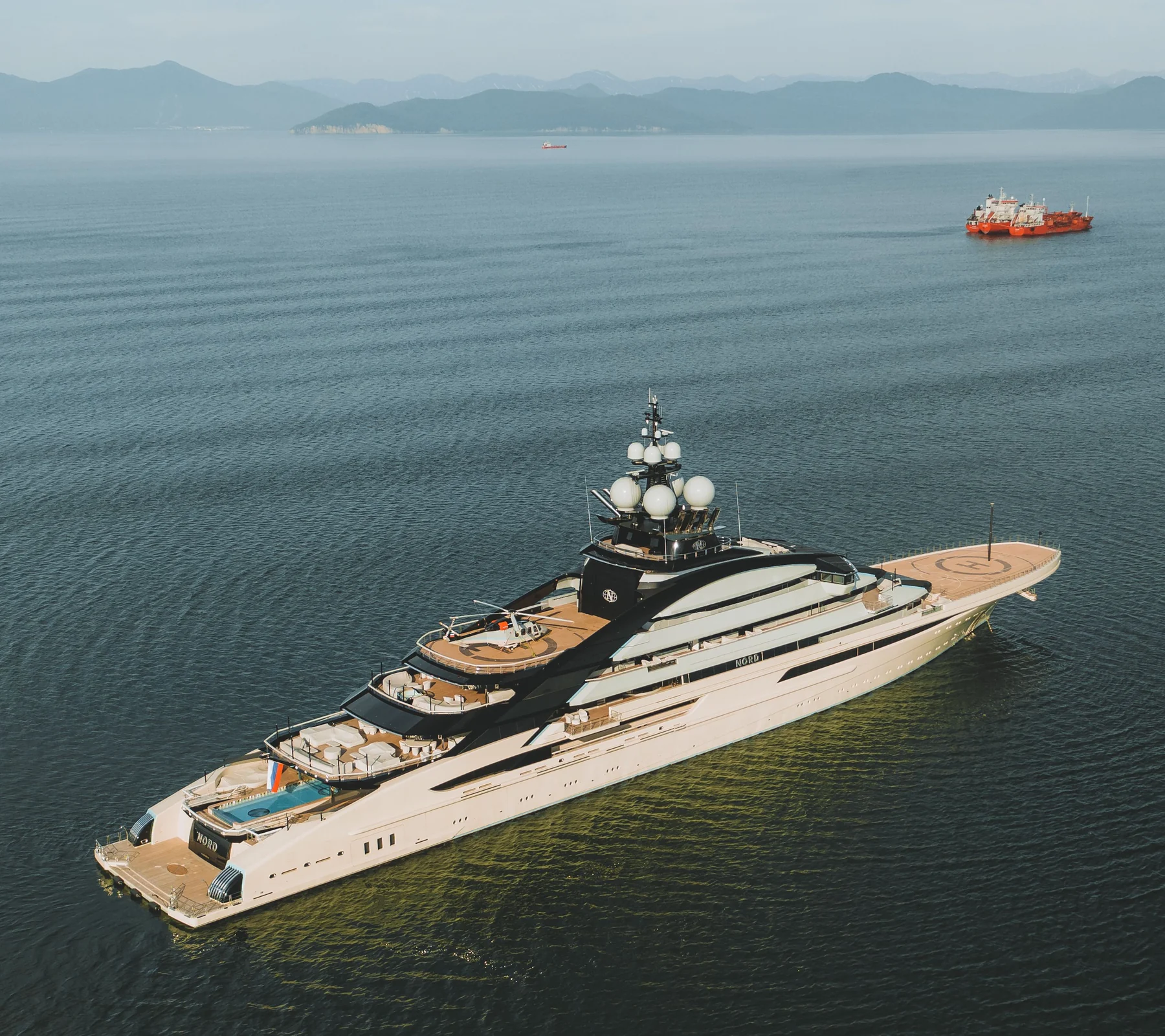 Real photograph of a large private megayacht at sea.