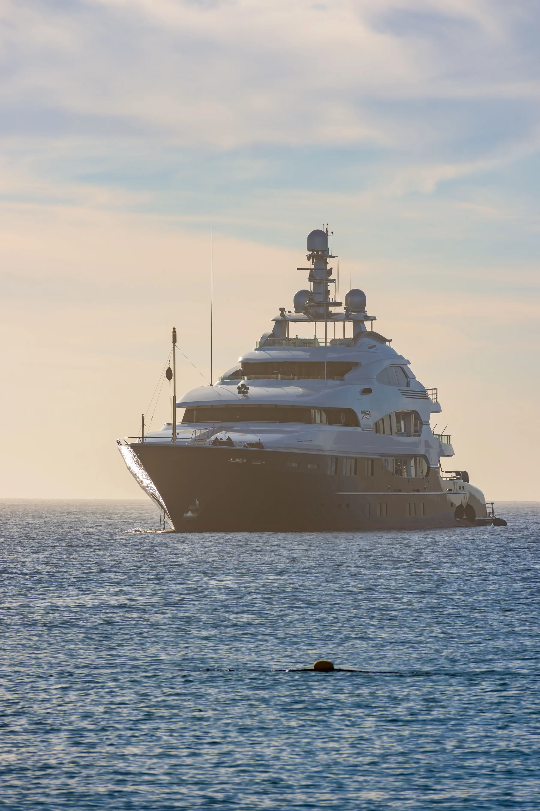 Real photograph of a large private megayacht at sea.